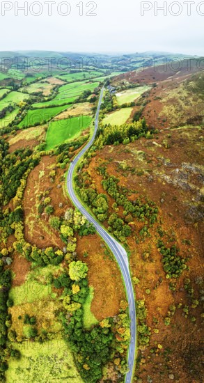 Autumn colours of Farms over River Wye and Road A470 from a drone, Llanidloes, Powys, Montgomeryshire, Wales, UK