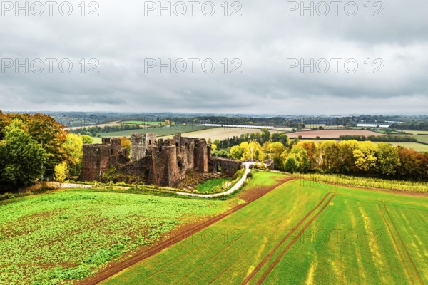 Autumn Colours over ruins of Goodrich Castle and River Wye from a drone, Goodrich, Herefordshire, England, United Kingdom