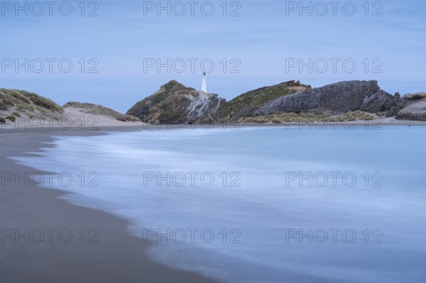 Deliverance Cove and Castlepoint Lighthouse on the rock, ocean, long exposure, evening. Castlepoint, Wairarapa Coast, Wellington Region, North Island, New Zealand