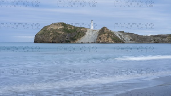 Castlepoint Beach with lighthouse on the rock, ocean, long exposure. Castlepoint, Wairarapa Coast, Wellington Region, North Island, New Zealand