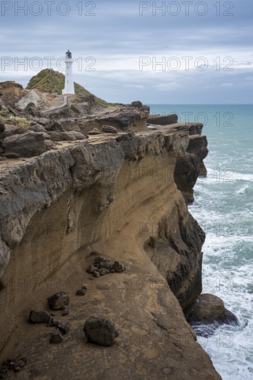 Castlepoint lighthouse on a rock, ocean. Castlepoint, Wairarapa Coast, Wellington Region, North Island, New Zealand