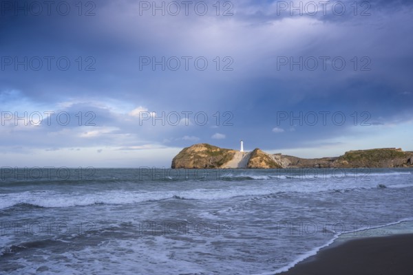 Castlepoint Beach, ocean and lighthouse on a rock. Castlepoint, Wairarapa Coast, Wellington Region, North Island, New Zealand