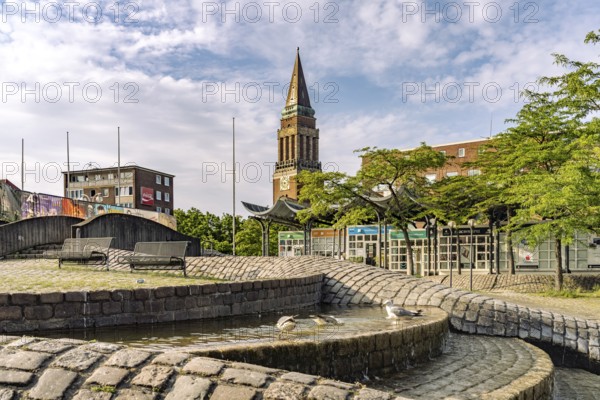 Fountain on Europaplatz and the tower of the town hall in Kiel, Schleswig-Holstein, Germany