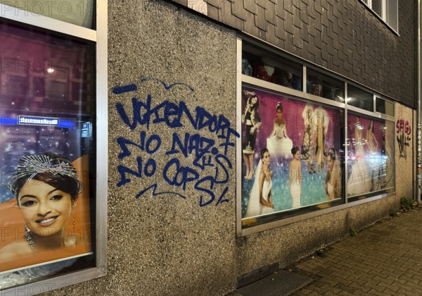 Facade smeared with Ückendorf No Nazis No Cops in one of the poorest cities in Germany, Gelsenkirchen, Ruhr area, North Rhine-Westphalia, Germany