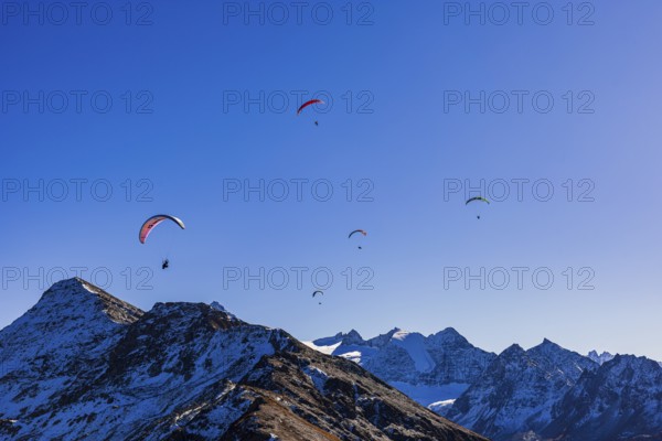 Paragliders fly over the mountains of the Valais Alps, Val d'Anniviers, Valais Alps, Canton of Valais, Switzerland