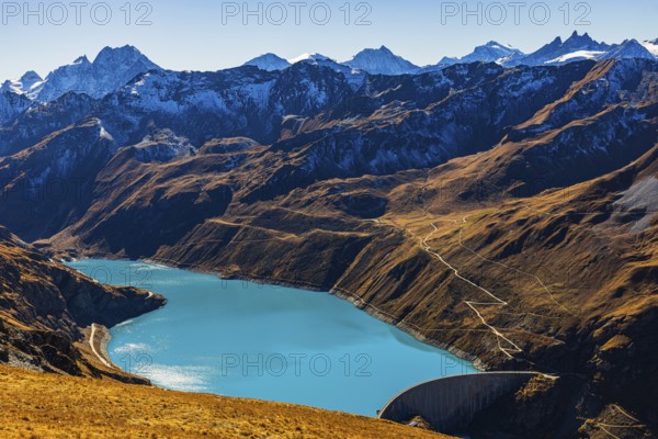 The turquoise Lac de Moiry reservoir with the dam, behind the peaks of the Grand Cornier, Tete Blanche and Pointe Moiry mountains, Val d'Anniviers, Valais Alps, Canton of Valais, Switzerland
