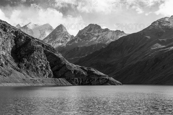 The Lac de Moiry reservoir, in the background the peaks of the Grand Cornier, Tete Blanche and Pointe Moiry mountains, black and white photo, Val d'Anniviers, Valais Alps, Canton of Valais, Switzerland