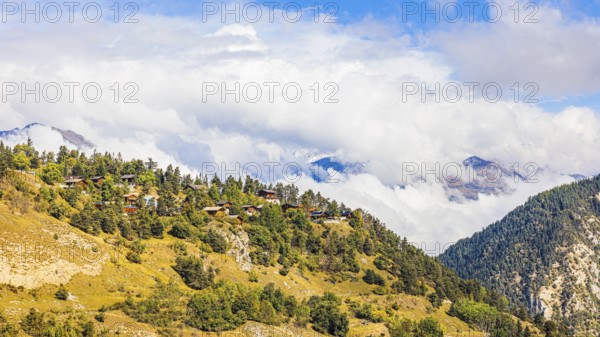 Rising fog over the mountain village of Vercorin, Val d'Anniviers, Valais Alps, Canton of Valais, Switzerland