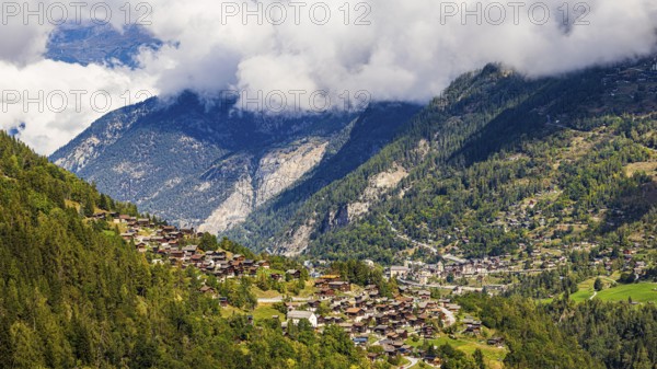 Rising fog in the Val d'Anniviers, below the mountain village of Saint-Jean, Valais Alps, Canton of Valais, Switzerland