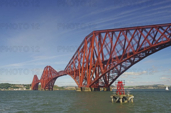 A distinctive red bridge spanning a wide river under clear skies, railway bridge, Firth of Forth, Edinburgh, Scotland, Great Britain