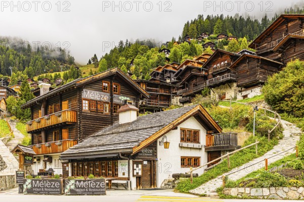 Hotel Restaurant Meleze in front of historic farmhouses, Grimentz, Val d'Anniviers, Valais Alps, Canton of Valais, Switzerland