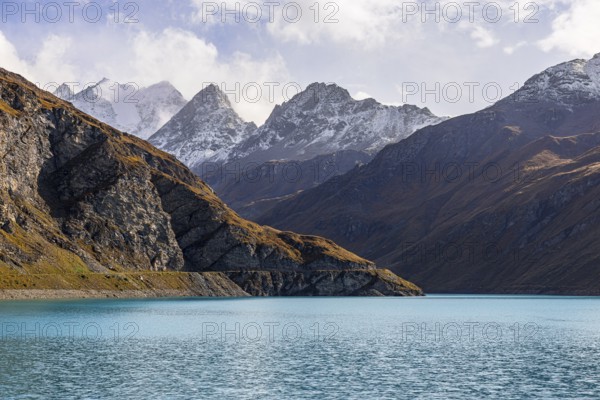 The turquoise Lac de Moiry reservoir, behind the peaks of the Grand Cornier, Tete Blanche and Pointe Moiry mountains, Val d'Anniviers, Valais Alps, Canton of Valais, Switzerland