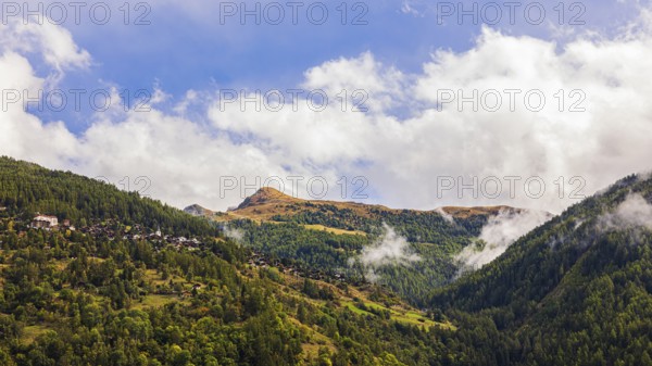 Fog rises in Val d'Anniviers, behind the Pointes de Nava hill, Valais Alps, Canton of Valais, Switzerland