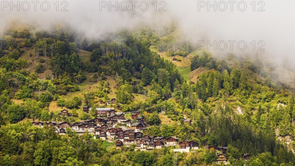 Fog over the mountain village of Pinsec, Val d'Anniviers, Valais Alps, Canton of Valais, Switzerland