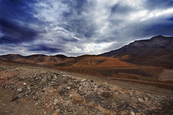 Dramatic mountain landscape with cloudy sky and rugged terrain, Pajara Fuerteventura, Canary Island