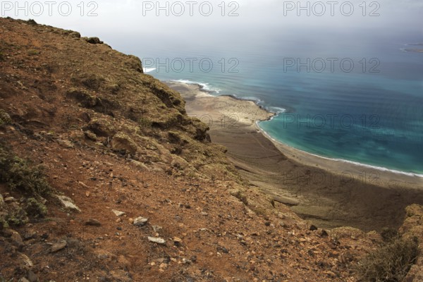 Steep slope overlooking the sea under a cloudy sky, Haria Lanzarote, Canary Island