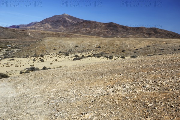 Wide, dry hilly landscape with a distant mountain under clear skies, Playa Blanca Lanzarote, Canary Island