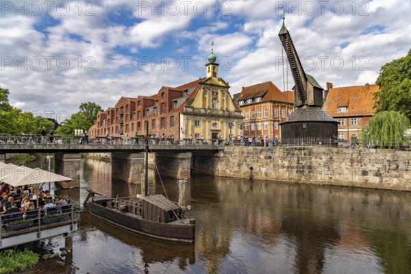 Old harbour with crane and hotel department store in the Hanseatic city of Lüneburg, Lower Saxony, Germany