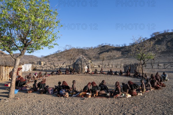 People sitting in a circle, traditional Himba village, Kaokoveld, Kunene, Namibia
