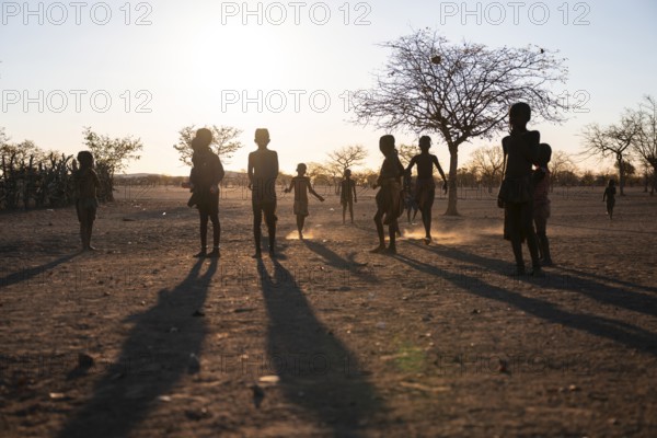 Himba children playing, evening mood, traditional Himba village, Kaokoveld, Kunene, Namibia