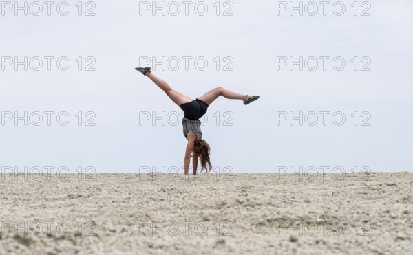 Abstract, woman doing gymnastics in a whirring landscape, Etosha pan, Etosha National Park, Namibia