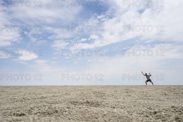 Symbolic picture, abstract, man at the Etosha pan, salt pan, Etosha National Park, Namibia