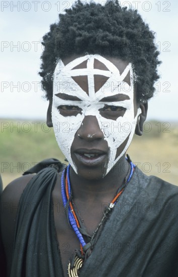 Portrait of a Maasai boy with face painted white on the occasion of his initiation, Ngorongoro Crater, Tanzania, Africa, June 2000, vintage, retro, old, historical