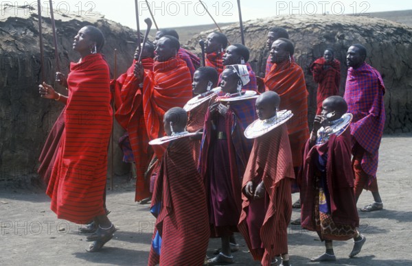 Maasai men and girls in their village in the Ngorongoro Crater dancing for tourists, Tanzania, Africa, June 2000, vintage, retro, old, historic