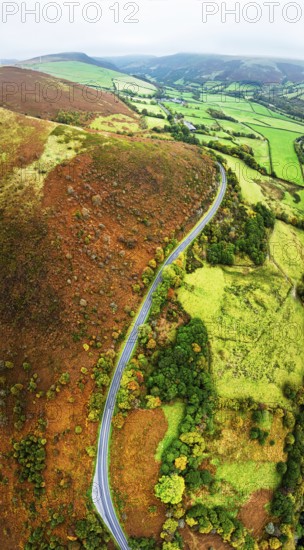 Autumn colours of Farms over River Wye and Road A470 from a drone, Llanidloes, Powys, Montgomeryshire, Wales, UK