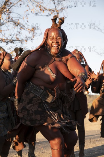 Himba woman dancing euphorically, traditional dance, traditional Himba village, Kaokoveld, Kunene, Namibia