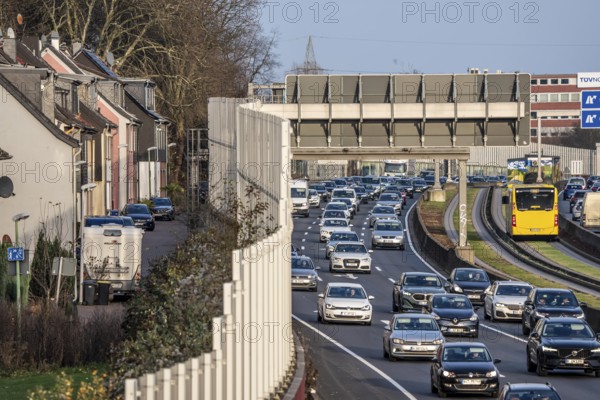 Residential buildings directly on the A40 motorway, noise barrier, heavy traffic near the Essen-Ost motorway junction, view to the west, 6-lane motorway, with 2 bus lanes in the middle, rush hour traffic, North Rhine-Westphalia, Germany