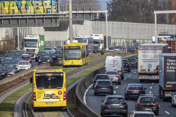 Heavy traffic on the A40 motorway, Ruhrschnellweg, height of the Essen-Ost motorway junction, looking east, 6-lane motorway, with 2 bus lanes in the middle, rush hour traffic, North Rhine-Westphalia, Germany
