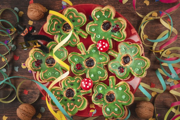 Shamrock shaped cookies with green icing and decoration for New Year