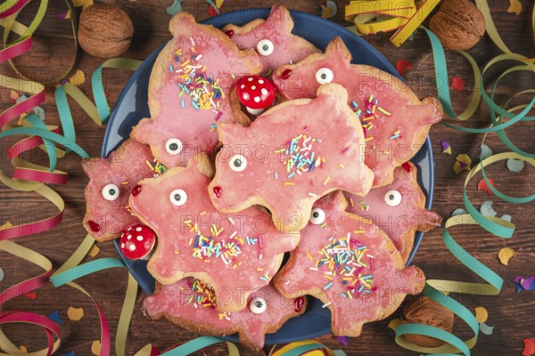 Pig-shaped cookies with pink icing and decoration for New Year's Eve