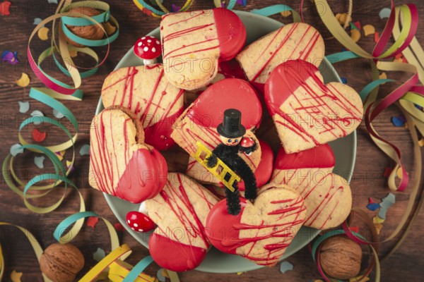 Heart-shaped cookies with red icing and decoration for New Year