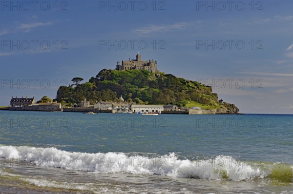 A castle on a hill overlooks the sea with gentle waves, Saint Michael's Mount, Pencanze, Cornwall, United Kingdom