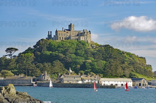 A majestic castle perched on a green hill in front of the sea, Penzance, Saint Michael's Mount, Cornwall, Great Britain