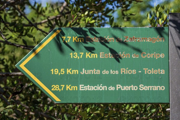 Signpost showing distances along cycle path Via Verde de la Sierra, Puerto Serrano to Olvera, old railroad track, Andalusia, Spain