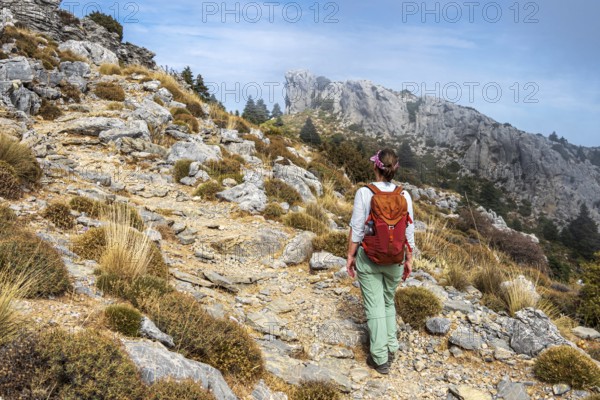 Woman hiking in the mountain range Sierra de las Nieves, near Yunquera, Andalusia, Spain
