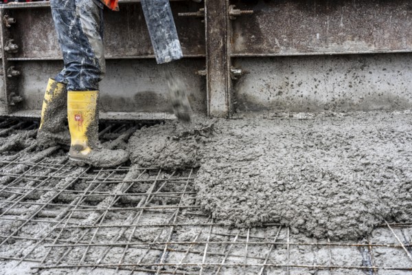 Concreting, concreting the foundation of a wind turbine, concrete pump hose, more than 600 cubic meters of concrete will be pumped into the foundation for over 7 hours, over 100 tons of reinforcing steel have been used, the wind turbine will have a hub height of 160 meters, part of a new wind farm in Sauerland, near Balve, North Rhine-Westphalia, Germany