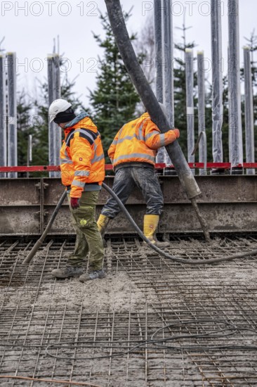 Concreting, concreting the foundation of a wind turbine, more than 600 cubic meters of concrete will be pumped into the foundation for over 7 hours, over 100 tons of reinforcing steel have been used, the wind turbine will have a hub height of 160 meters, part of a new wind farm in Sauerland, near Balve, North Rhine-Westphalia, Germany