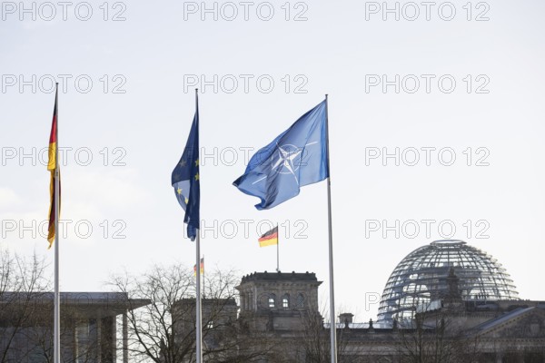 Flags of the Federal Republic of Germany, the EU and NATO in front of the Reichstag building, Berlin, 11.12.2025