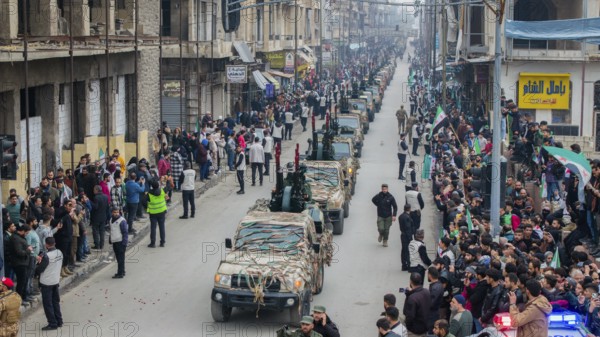 Aleppo, Syria – December 08, 2025: Aerial shots capture the Syrian Army and Public Security forces conducting a military parade on the first anniversary of the Syrian revolution's victory and the fall of the Assad regime, attended by thousands of people, Aleppo, Aleppo, Syria