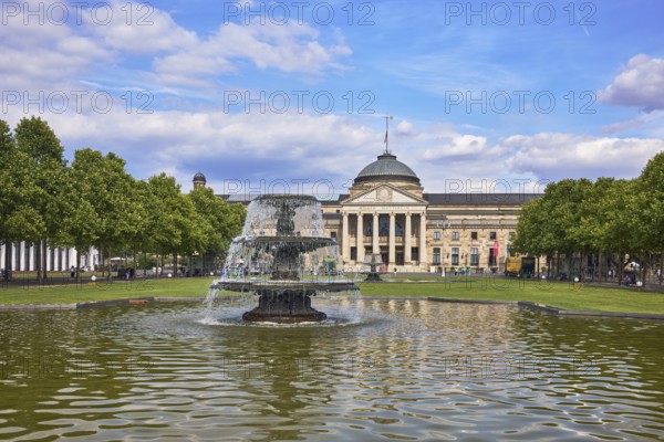 Spa hotel, neo-classical style, architect Friedrich von Thiersch, columns, gardens, trees, lawn, bowling green, abstract reflections on the water surface, blue sky, cumulus clouds, Kurhausplatz square, Wiesbaden, state capital, district-free city, Hesse, Germany