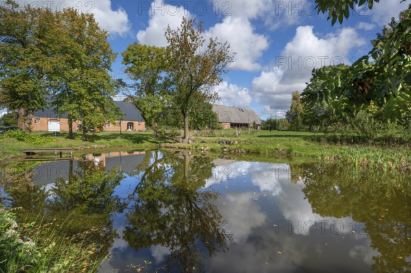 Historic horse stable and barn with pond, 1923, at the Othenstorf estate, Othenstorf, Mecklenburg-Western Pomerania, Germany