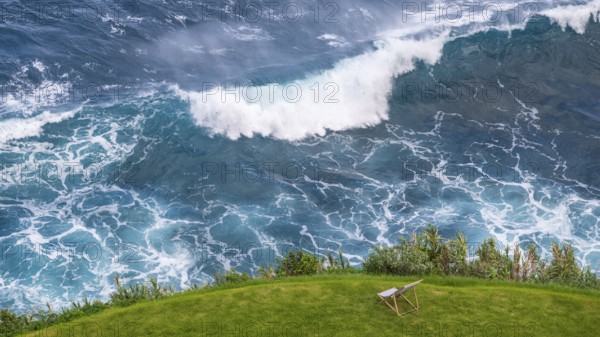 Deckchair in a meadow off coast with waves in the sea, beautiful view, Madeira, Portugal