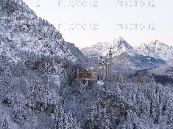 Neuschwanstein Castle rises in a snow-covered mountain landscape with romantic flair, Schwangau near Füssen, Ostallgäu, Allgäu, Bavaria, Germany