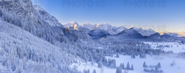 Wide snowy mountain landscape with clear skies and a wide view of the Alps, Neuschwanstein Castle, Schwangau near Füssen, Ostallgäu, Allgäu, Bavaria, Germany