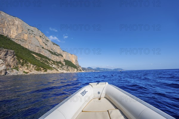 Motorboat trip along the picturesque rocky coast, cliffs and blue sea, Golfo di Orosei, Baunei, Sardinia, Italy