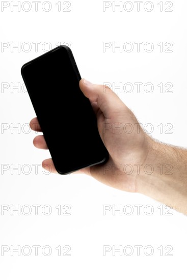 Hand holding a black smartphone against a white background